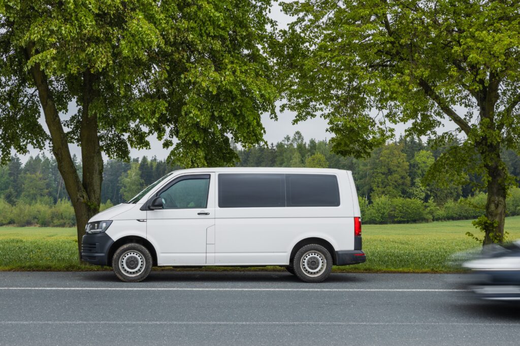 A white van parked beside a scenic road in Kácov, Středočeský kraj, Czech Republic.